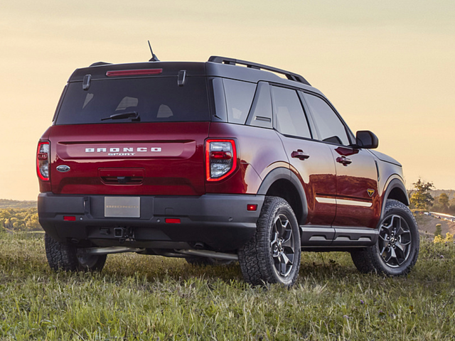 Rear view of a dark red 2024 Ford Bronco Sport parked in a field. | Ford dealer in Suitland, MD | Banister Ford of Marlow Heights