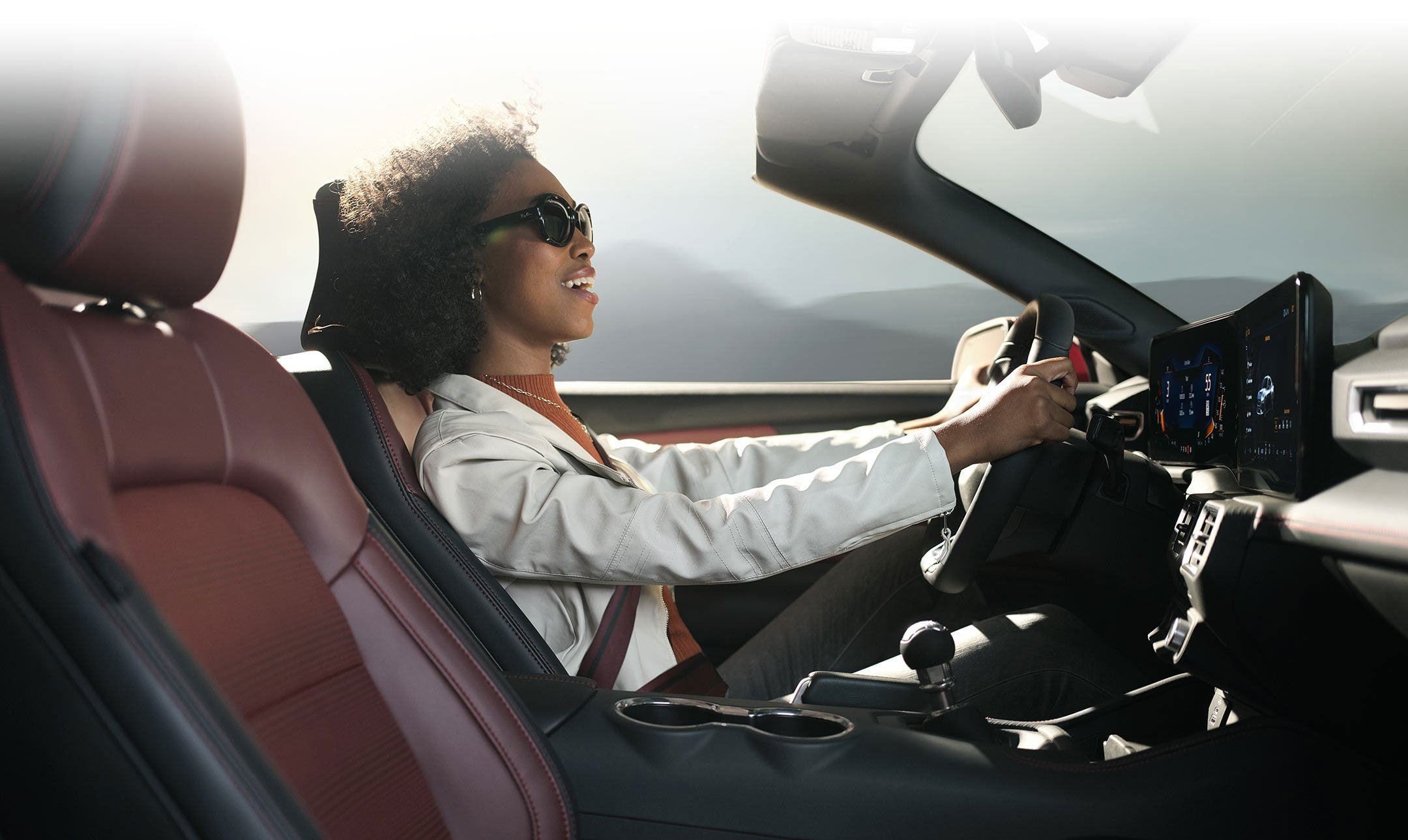 Person sitting in the driver’s seat of a 2024 Ford Mustang® convertible | Banister Ford of Marlow Heights in Suitland MD